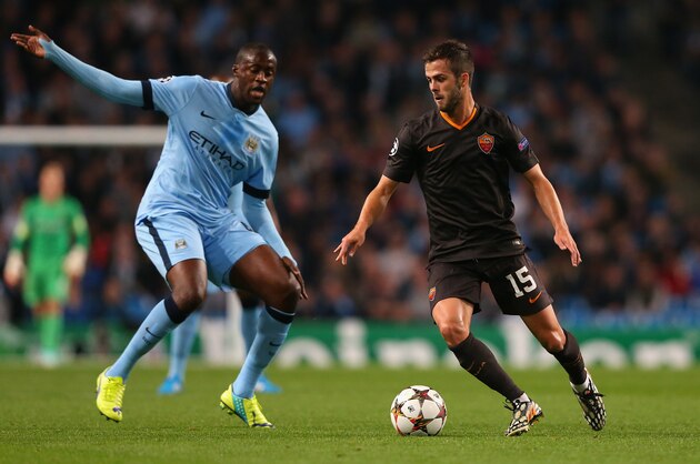 MANCHESTER, ENGLAND - SEPTEMBER 30:  Miralem Pjanic of AS Roma competes with Yaya Toure of Manchester City during the UEFA Champions League Group E match between Manchester City FC and AS Roma  on September 30, 2014 in Manchester, United Kingdom.  (Photo by Alex Livesey/Getty Images)
