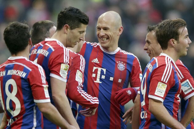 Bayern's Arjen Robben from the Netherlands, center, celebrates with team mates after Franck Ribery from France scored his side's 7th goal during the German first division Bundesliga soccer match between FC Bayern Munich and Hamburger SV in the Allianz Arena in Munich, Germany, Saturday, Feb. 14, 2015. (AP Photo/Matthias Schrader)
