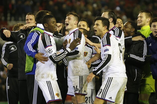 Basel players celebrate at the end of the Champions League Group B soccer match between Liverpool and FC Basel at Anfield Stadium in Liverpool, England, Tuesday, Dec. 9, 2014. The match ended 1-1. (AP Photo/Jon Super)