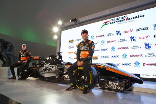 Drivers Sergio Perez, right, and Nico Hulkenberg sit on the newly unveiled Sahara Force India team car, at a press event to announce the 2015 Formula One racing team, at the Soumaya Museum in Mexico City, Wednesday, Jan. 21, 2015. (AP Photo/Rebecca Blackwell)