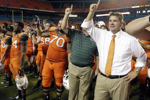 Miami head coach Al Golden, right, sings the alma mater with the team after Miami defeated Florida A&M 41-7 in an NCAA football game, Saturday, Sept. 6, 2014, in Miami Gardens, Fla. (AP Photo/Lynne Sladky)