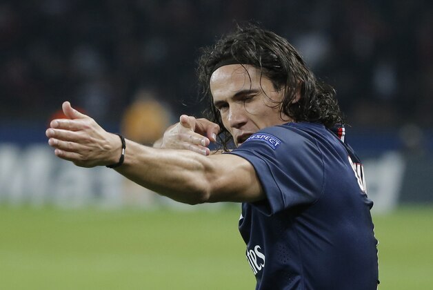 PSG's Edinson Cavani celebrates his opening goal during the Champions League Group F soccer match between Paris Saint Germain and Ajax at Parc des Princes stadium in Paris, France, Tuesday, Nov. 25, 2014. (AP Photo/Francois Mori)