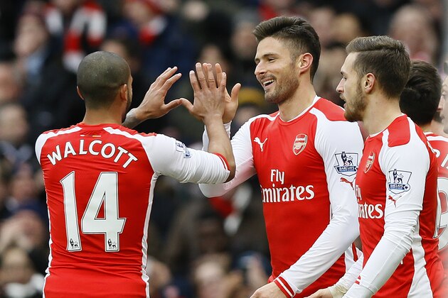 Arsenal's Olivier Giroud, center, celebrates scoring a goal during the English Premier League soccer match between Arsenal and Aston Villa at the Emirates stadium in London, Sunday, Feb. 1, 2015. (AP Photo/Kirsty Wigglesworth)