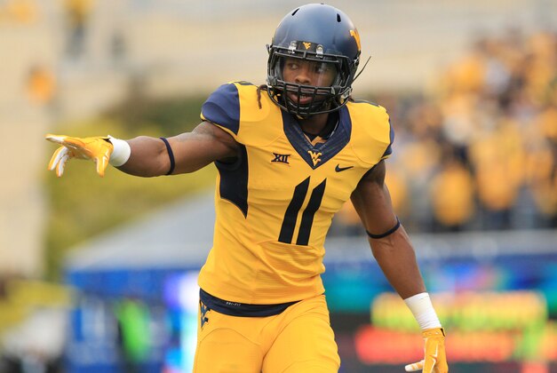 West Virginia's Kevin White (11) checks is lineup during their NCAA college football game against Kansas in Morgantown, W.Va., Saturday, Oct. 4, 2014. West Virginia won 33-14. (AP Photo/Chris Jackson)
