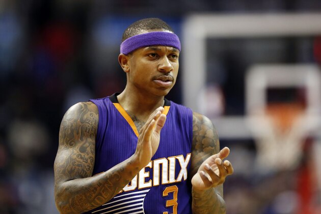 Phoenix Suns guard Isaiah Thomas applauds on the court late in the second half of an NBA basketball game against the Washington Wizards, Sunday, Dec. 21, 2014, in Washington. The Suns won 104-92. (AP Photo/Alex Brandon)