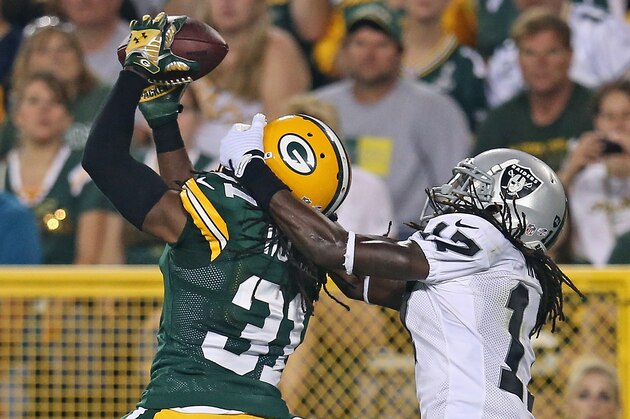 GREEN BAY, WI - AUGUST 22:  Davon House #31 of the Green Bay Packers breaks up a pass intended for Denarius Moore #17 of the Oakland Raiders during the second quarter of a preseason game at Lambeau Field on August 22, 2014 in Green Bay, Wisconsin.  (Photo by Jonathan Daniel/Getty Images)