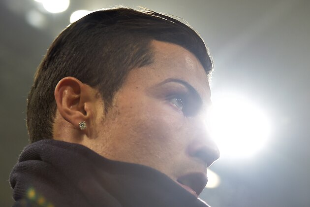 Real's superstar Christiano Ronaldo walks in front of the stadium lights during the last training session in the stadium prior the Champions League round of 16 first leg soccer match between FC Schalke 04 and Real Madrid in Gelsenkirchen, Germany, Tuesday, Feb. 17, 2015. (AP Photo/Martin Meissner)