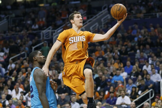 Phoenix Suns guard Goran Dragic, of Slovenia, drives past Charlotte Hornets forward Marvin Williams during the second half of an NBA basketball game, Friday, Nov. 14, 2014, in Phoenix. (AP Photo/Matt York)