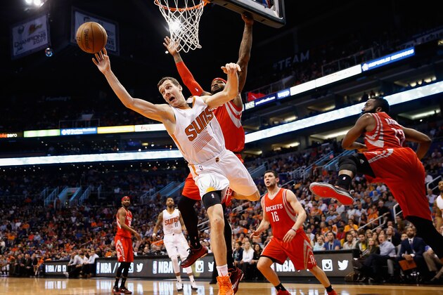 PHOENIX, AZ - FEBRUARY 10:  Goran Dragic #1 of the Phoenix Suns makes a leaping pass ahead of Josh Smith #5 of the Houston Rockets during the second half of the NBA game at US Airways Center on February 10, 2015 in Phoenix, Arizona. NOTE TO USER: User expressly acknowledges and agrees that, by downloading and or using this photograph, User is consenting to the terms and conditions of the Getty Images License Agreement.  (Photo by Christian Petersen/Getty Images)