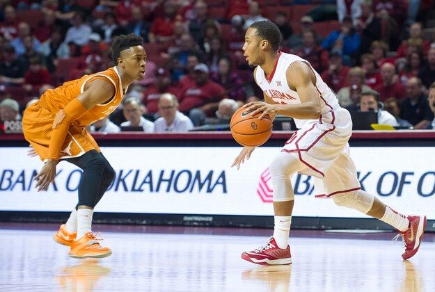 Feb 17, 2015; Norman, OK, USA; Oklahoma Sooners guard Jordan Woodard (10) moves the ball Texas Longhorns guard Isaiah Taylor (1) during the first quarter at Lloyd Noble Center. Mandatory Credit: Rob Ferguson-USA TODAY Sports