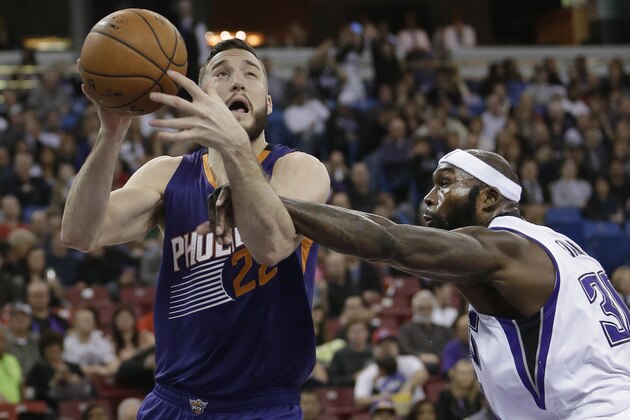 Phoenix Suns center Mile Plumlee, left, is fouled by Sacramento Kings forward Reggie Evans during the first quarter of an NBA basketball game in Sacramento, Calif., Friday, Dec. 26, 2014. (AP Photo/Rich Pedroncelli)