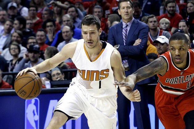 Phoenix Suns guard Goran Dragic, from Slovenia, left, drives on Portland Trail Blazers guard Damian Lillard during the first half of an NBA basketball game in Portland, Ore., Thursday, Feb. 5, 2015.  (AP Photo/Don Ryan)