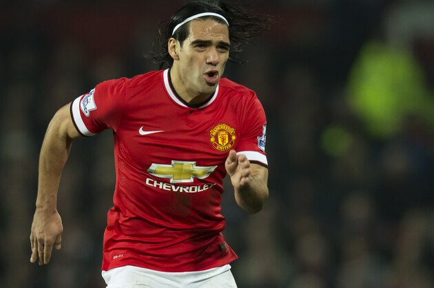 Manchester United's Radamel Falcao takes the ball downfield during the English Premier League soccer match between Manchester United and Burnley at Old Trafford Stadium, Manchester, England, Wednesday Feb. 11, 2015. (AP Photo/Jon Super)