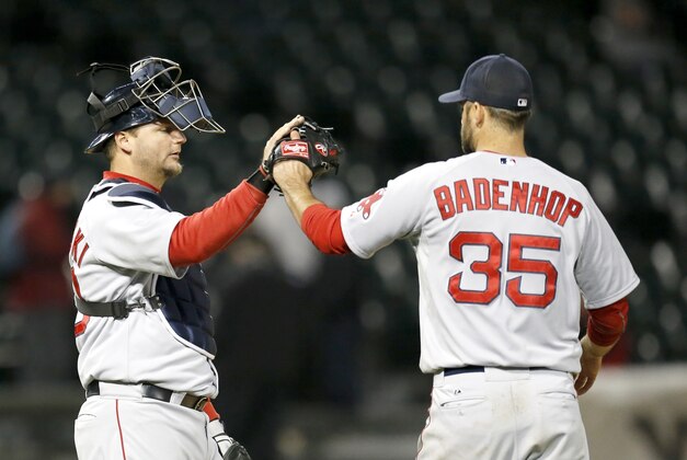 Boston Red Sox relief pitcher Burke Badenhop, right,  celebrates with catcher A.J. Pierzynski the Red Sox's 6-4 win over the Chicago White Sox after the14th inning of a baseball game Thursday, April 17, 2014, in Chicago. (AP Photo/Charles Rex Arbogast)