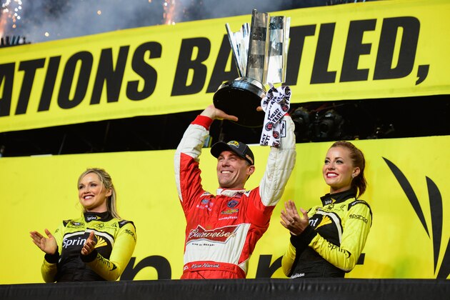 HOMESTEAD, FL - NOVEMBER 16:  Kevin Harvick, driver of the #4 Budweiser Chevrolet, celebrates with the trophy in victory lane after winning the NASCAR Sprint Cup Series Ford EcoBoost 400 at Homestead-Miami Speedway on November 16, 2014 in Homestead, Florida.  (Photo by Robert Laberge/Getty Images)