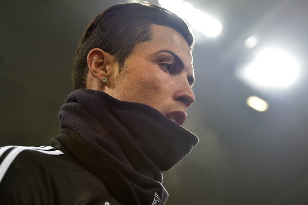 Real's superstar Christiano Ronaldo walks in front of the stadium lights during the last training session in the stadium prior the Champions League round of 16 first leg soccer match between FC Schalke 04 and Real Madrid in Gelsenkirchen, Germany, Tuesday, Feb. 17, 2015. (AP Photo/Martin Meissner)