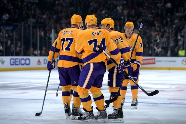 LOS ANGELES, CA - FEBRUARY 12: Members of the Los Angeles Kings including Jeff Carter #77, Dwight King #74 and Tyler Toffoli #73 celebrate a goal during a game against the Calgary Flames at STAPLES Center on February 12, 2015 in Los Angeles, California. (Photo by Aaron Poole/NHLI via Getty Images)
