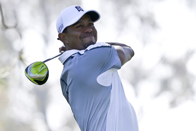 Tiger Woods watches his tee shot head far to the right on the 11th hole of the north course at Torrey Pines during the first round of the Farmers Insurance Open golf tournament Thursday, Feb. 5, 2015, in San Diego. (AP Photo/Lenny Ignelzi)