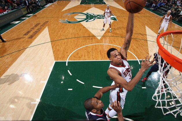 MILWAUKEE, WI - DECEMBER 27: John Henson #31 of the Milwaukee Bucks dunks against the Atlanta Hawks during the game on December 27, 2014 at the BMO Harris Bradley Center in Milwaukee, Wisconsin. NOTE TO USER:  User expressly acknowledges and agrees that, by downloading and or using this Photograph, user is consenting to the terms and conditions of the Getty Images License Agreement.  Mandatory Copyright Notice:  Copyright 2014 NBAE (Photo by Gary Dineen/NBAE via Getty Images)