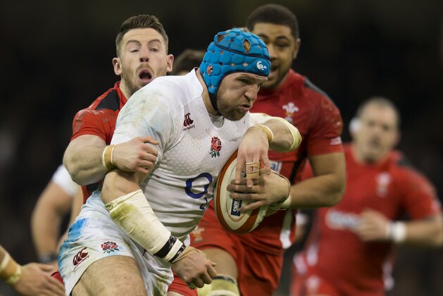 England's James Haskell, centre, attempts to get clear of Wales' Alex Cuthbert, left, during their 6 Nations Championship Rugby match at the Millennium Stadium, Cardiff, Friday Feb. 6, 2015. (AP Photo/Jon Super)