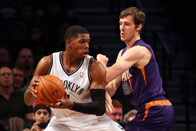 Mar 17, 2014; Brooklyn, NY, USA;   Brooklyn Nets guard Joe Johnson (7) drives on Phoenix Suns guard Goran Dragic (1) during the first quarter at Barclays Center. Mandatory Credit: Anthony Gruppuso-USA TODAY Sports