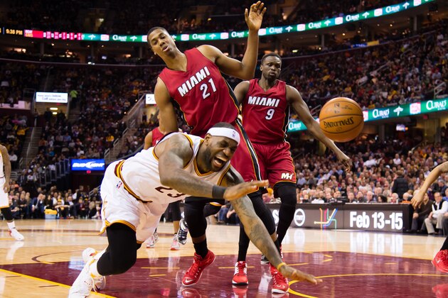 CLEVELAND, OH - FEBRUARY 11: LeBron James #23 of the Cleveland Cavaliers falls after colliding with Hassan Whiteside #21 of the Miami Heat during the second half at Quicken Loans Arena on February 11, 2015 in Cleveland, Ohio. The Cavaliers defeated the Heat 113-93. NOTE TO USER: User expressly acknowledges and agrees that, by downloading and or using this photograph, User is consenting to the terms and conditions of the Getty Images License Agreement. (Photo by Jason Miller/Getty Images)