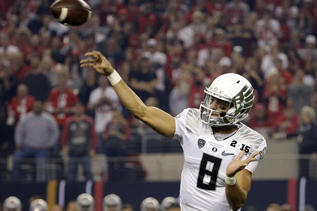 Oregon's Marcus Mariota throws during the first half of the NCAA college football playoff championship game against Ohio State Monday, Jan. 12, 2015, in Arlington, Texas. (AP Photo/David J. Phillip)