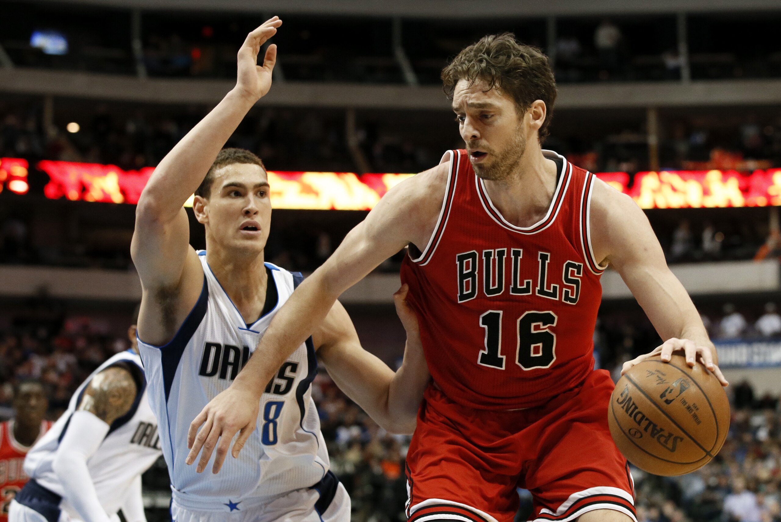 Dallas Mavericks forward Dwight Powell (8) defends as Chicago Bulls forward Pau Gasol (16), of Spain, moves toward the basket in the first half of an NBA basketball game, Friday, Jan. 23, 2015, in Dallas. (AP Photo/Tony Gutierrez)