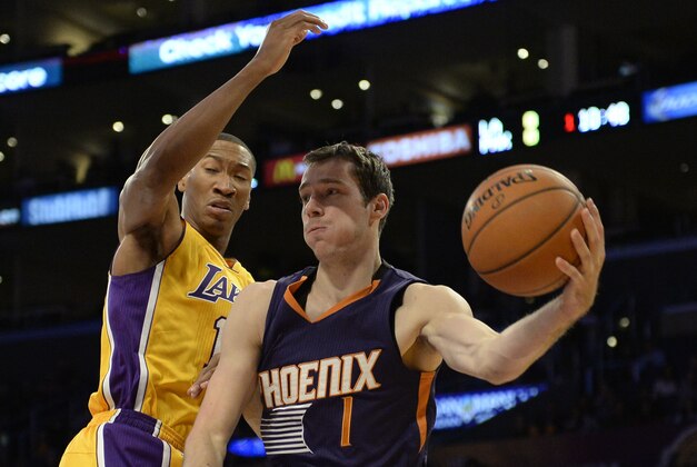 Nov 4, 2014; Los Angeles, CA, USA; Phoenix Suns guard Goran Dragic (1) passes the basketball against Los Angeles Lakers forward Wesley Johnson (left) during the first quarter at Staples Center. Mandatory Credit: Richard Mackson-USA TODAY Sports