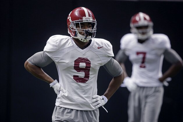 Alabama wide receivers Amari Cooper (9)  and Cam Sims (7) pause during practice at the Mercedes-Benz Superdome in New Orleans, Monday, Dec. 29, 2014. They will square off against Ohio State in the Allstate Sugar Bowl NCAA football game, which will be played Jan. 1, 2015. (AP Photo/Gerald Herbert)