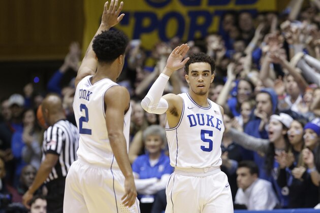 Duke's Quinn Cook (2) and Tyus Jones (5) react during the first half of an NCAA college basketball game against Notre Dame in Durham, N.C., Saturday, Feb. 7, 2015. (AP Photo/Gerry Broome)