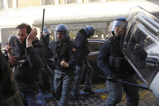 Italian policemen clash with Feyenoord's fans at the Spanish steeps, in downtown Rome, prior to the Europa League soccer match between Roma and Feyenoord, Thursday, Feb. 19, 2015. (AP Photo/Gregorio Borgia)