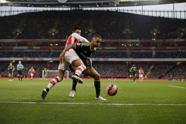 Arsenal's Alexis Sanchez, left, competes with Middlesbrough's Ryan Fredericks during the English FA Cup fifth round soccer match between Arsenal and Middlesbrough at the Emirates Stadium in London, Sunday, Feb. 15, 2015.  (AP Photo/Matt Dunham)