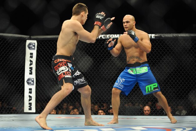 Nov 16, 2013; Las Vegas, NV, USA; Rory MacDonald (red gloves) fights against Robbie Lawler (blue gloves) in their welterweight bout during UFC 167 at MGM Grand Garden Arena. Mandatory Credit: Stephen R. Sylvanie-USA TODAY Sports