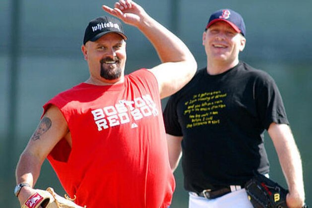 Boston Red Sox pitcher David Wells, left, simulates a throw while fielding grounders with Curt Schilling on the first day of the team's spring training Thursday, Feb. 17, 2005, in Ft. Myers, Fla. (AP Photo/Robert F. Bukaty)