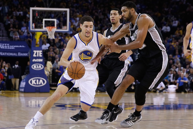 OAKLAND, CA - NOVEMBER 11:  Klay Thompson #11 of the Golden State Warriors drives on Tim Duncan #21 of the San Antonio Spurs at ORACLE Arena on November 11, 2014 in Oakland, California. NOTE TO USER: User expressly acknowledges and agrees that, by downloading and or using this photograph, User is consenting to the terms and conditions of the Getty Images License Agreement.  (Photo by Ezra Shaw/Getty Images)