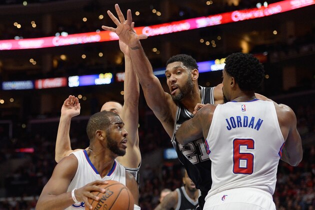 LOS ANGELES, CA - FEBRUARY 19:  Tim Duncan #21 of the San Antonio Spurs chases Chris Paul #3 of the Los Angeles Clippers around the screen of DeAndre Jordan #6 at Staples Center on February 19, 2015 in Los Angeles, California.  NOTE TO USER: User expressly acknowledges and agrees that, by downloading and or using this Photograph, user is consenting to the terms and condition of the Getty Images License Agreement.  (Photo by Harry How/Getty Images)