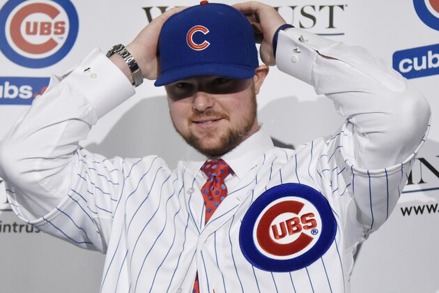 CHICAGO, IL - DECEMBER 15:  Pitcher Jon Lester puts on a Cubs hat during an introduction press conference by the Chicago Cubs on December 15, 2014  in Chicago, Illinois. (Photo by David Banks/Getty Images)