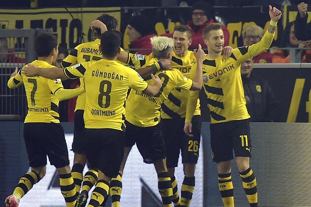 Dortmund's scorer Marco Reus, right, celebrates with his teammates after scoring during the German Bundesliga soccer match between Borussia Dortmund and FSV Mainz in Dortmund, Germany, Friday, Feb. 13, 2015. (AP Photo/Martin Meissner)