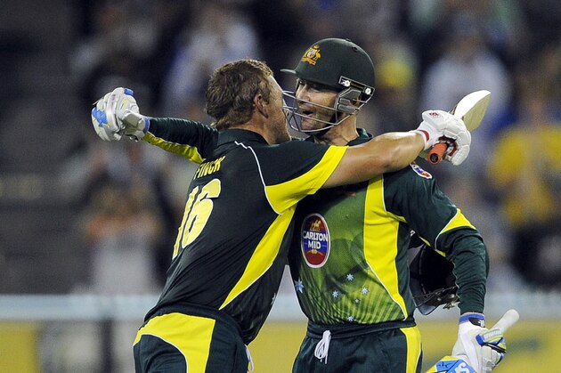 Australia's Aaron Finch, left, celebrates with his captain Michael Clarke, right, after making 100 runs against England during their one-day international cricket match at the Melbourne Cricket Ground in Melbourne, Australia, Sunday, Jan. 12, 2014. (AP Photo/Andy Brownbill)