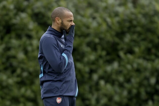 Arsenal's on loan former player, and the club's all time highest scorer, Thierry Henry takes part in a training session at the club's facilities in London Colney, England, Tuesday, Feb. 14, 2012.  Arsenal are due to play AC Milan in the first leg of their Champions League last 16 soccer match in Milan on Wednesday.  (AP Photo/Matt Dunham)