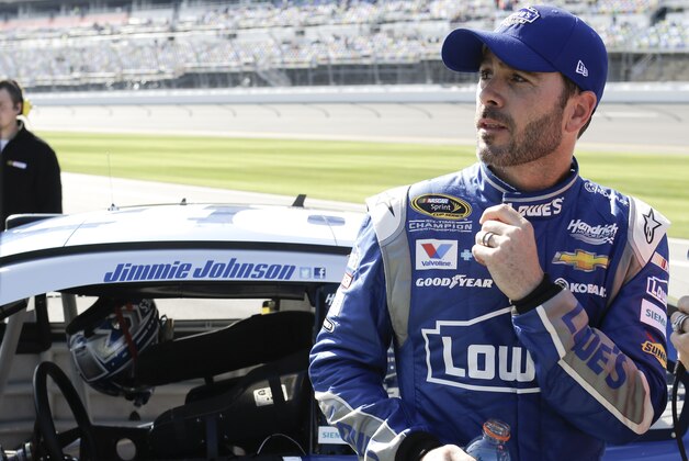 Jimmie Johnson looks at the leader board after qualifying for the Daytona 500 NASCAR Sprint Cup Series auto race at Daytona International Speedway, Sunday, Feb. 15, 2015, in Daytona Beach, Fla.  Johnson will start in the number 2 position.(AP Photo/John Raoux)
