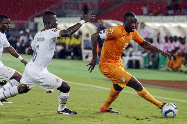 Ivory Coast's captain Yaya Toure, right, is challenged by Ghana's Afriyie Acquah, center, and teammate Mubarak Wakaso, left, during their African Cup of Nations final soccer match in Bata, Equatorial Guinea, Sunday, Feb. 8, 2015. (AP Photo/Themba Hadebe)