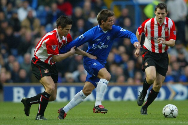 LONDON - NOVEMBER 30:  Quique De Lucas of Chelsea holds off Paul Thirlwell of Sunderland during the Barclaycard Premiership match between Chelsea and Sunderland at Stamford Bridge in London on November 30, 2002. (Photo By Ben Radford/Getty Images)