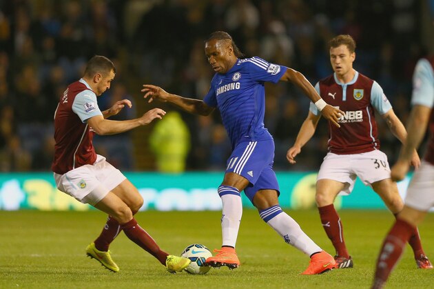 BURNLEY, ENGLAND - AUGUST 18:  Didier Drogba of Chelsea looks to go past Dean Marney of Burnley during the Barclays Premier League match between Burnley and Chelsea at Turf Moor on August 18, 2014 in Burnley, England.  (Photo by Clive Brunskill/Getty Images)
