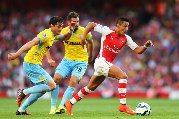 LONDON, ENGLAND - AUGUST 16:  Alexis Sanchez of Arsenal goes past Joel Ward (L) and Joe Ledley of Crystal Palace during the Barclays Premier League match between Arsenal and Crystal Palace at Emirates Stadium on August 16, 2014 in London, England.  (Photo by Clive Mason/Getty Images)