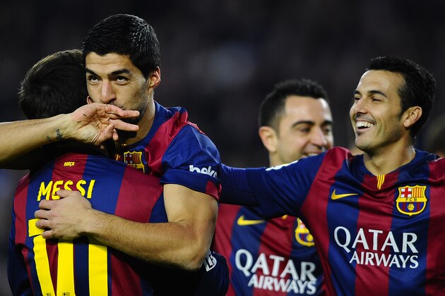 FC Barcelona's Luis Suarez from Uruguay, second left, reacts after scoring with his teammate Lionel Messi, from Argentina, left, against Levante during a Spanish La Liga soccer match at the Camp Nou stadium in Barcelona, Spain, Sunday, Feb. 15, 2015. (AP Photo/Manu Fernandez)