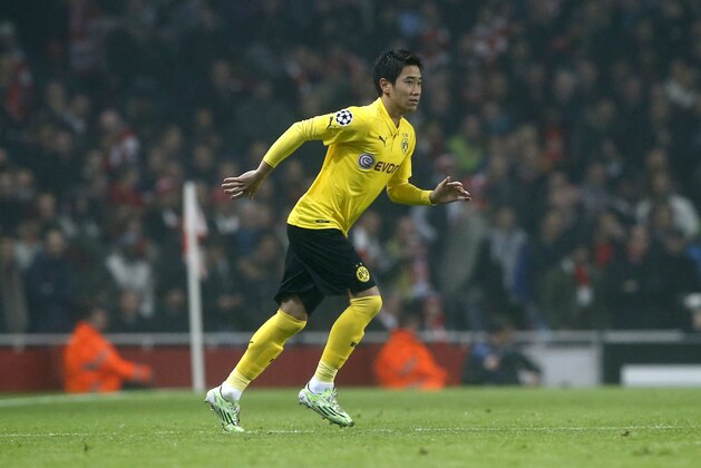 Dortmund's Shinji Kagawa runs on the pitch during the Champions League group D soccer match between Arsenal and Borussia Dortmund at the Emirates stadium in London, Wednesday, Nov. 26, 2014. (AP Photo/Alastair Grant)