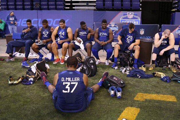 Feb 20, 2015; Indianapolis, IN, USA; Offensive linemen rest on a bench after finishing their workout during the 2015 NFL Combine at Lucas Oil Stadium. Mandatory Credit: Brian Spurlock-USA TODAY Sports
