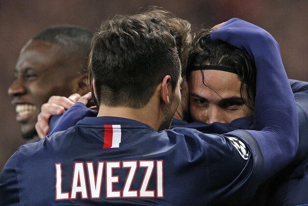 PSG's Edinson Cavani, right, celebrates with PSG's Ezequiel Lavezzi after scoring his side's first goal during the Champions League round of 16 first leg soccer match between Paris Saint Germain and Chelsea at the Parc des Princes stadium in Paris, France, Tuesday, Feb. 17, 2015. (AP Photo/Christophe Ena)